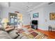 Bright living room featuring hardwood floors, comfortable seating, and access to a relaxing screened porch at 1933 Sterling Glen Ct, Sun City Center, FL 33573