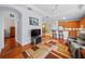 Living room features hardwood floors, a comfy couch and access to the kitchen at 1933 Sterling Glen Ct, Sun City Center, FL 33573