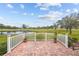 Brick patio with white railing and pond view at 1933 Sterling Glen Ct, Sun City Center, FL 33573