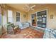 Bright sunroom with tiled floors, wicker furniture, and sliding glass doors at 1933 Sterling Glen Ct, Sun City Center, FL 33573