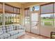 Bright sunroom with tiled floor, comfy seating and pond view at 1933 Sterling Glen Ct, Sun City Center, FL 33573