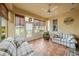 Bright sunroom with tiled floor, comfy seating and golf course view at 1933 Sterling Glen Ct, Sun City Center, FL 33573