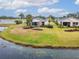 Aerial view of a house with a pond and lush landscaping at 1950 Sterling Glen Ct, Sun City Center, FL 33573