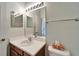 Clean bathroom with single sink vanity, mirror, and shower at 1950 Sterling Glen Ct, Sun City Center, FL 33573