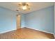 Light blue bedroom with wood floors and access to hallway at 1950 Sterling Glen Ct, Sun City Center, FL 33573