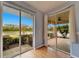 Light blue bedroom with wood floors and access to screened patio at 1950 Sterling Glen Ct, Sun City Center, FL 33573