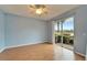 Light blue bedroom with wood floors and sliding glass doors at 1950 Sterling Glen Ct, Sun City Center, FL 33573