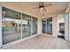 Bright enclosed patio with tile flooring, sliding glass doors, and ceiling fan at 1950 Sterling Glen Ct, Sun City Center, FL 33573