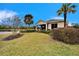 Back exterior view of a house featuring a screened patio and landscaping at 1950 Sterling Glen Ct, Sun City Center, FL 33573