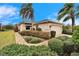 Exterior view of a house with a walkway and nicely landscaped yard at 1950 Sterling Glen Ct, Sun City Center, FL 33573