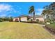 House exterior showcasing a side view with landscaping and lawn at 1950 Sterling Glen Ct, Sun City Center, FL 33573