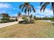 Exterior of house with a paved driveway and landscaping near a pond at 1950 Sterling Glen Ct, Sun City Center, FL 33573