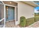 Welcoming front entrance with a blue door and screened porch at 1950 Sterling Glen Ct, Sun City Center, FL 33573