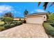 Attached garage with paver driveway and landscaping at 1950 Sterling Glen Ct, Sun City Center, FL 33573