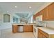 Kitchen features wood cabinets, tile floors, and a view at 1950 Sterling Glen Ct, Sun City Center, FL 33573