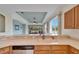 Kitchen with double sink, wood cabinets and water view at 1950 Sterling Glen Ct, Sun City Center, FL 33573