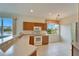 Kitchen with wood cabinets, white appliances, and a window at 1950 Sterling Glen Ct, Sun City Center, FL 33573