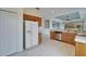 Bright kitchen with stainless steel dishwasher and white refrigerator at 1950 Sterling Glen Ct, Sun City Center, FL 33573