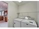 Laundry room has washer, dryer, and kitchen access at 1950 Sterling Glen Ct, Sun City Center, FL 33573