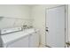 Laundry room with washer, dryer, and shelving at 1950 Sterling Glen Ct, Sun City Center, FL 33573