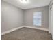 Simple bedroom with gray walls and carpet at 2002 E Ellicott St, Tampa, FL 33610