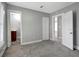 Bedroom with gray walls, carpet, and access to bathroom at 2002 E Ellicott St, Tampa, FL 33610