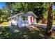 Gray house with red door and a spacious yard at 2002 E Ellicott St, Tampa, FL 33610