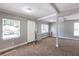 Spacious living room with gray walls and carpet at 2002 E Ellicott St, Tampa, FL 33610