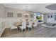 Open concept dining area with wood floors and white chairs at 20105 Umbria Hill Dr, Tampa, FL 33647