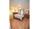 Charming bedroom with hardwood floors and built-in shelving at 207 S Mcmullen Booth Rd # 198, Clearwater, FL 33759