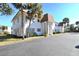 White two-story building with brown roof, landscaping, and parking at 207 S Mcmullen Booth Rd # 198, Clearwater, FL 33759