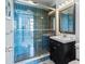 Modern bathroom with blue tile shower, vanity, and updated fixtures at 2109 Bayshore Blvd # 602, Tampa, FL 33606