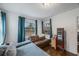 Bedroom with a brown couch and a full-length mirror at 2504 W Fletcher Ave, Tampa, FL 33618