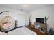 Bright bedroom with a comfy chair and hardwood floors at 2504 W Fletcher Ave, Tampa, FL 33618