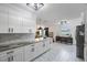 Open concept kitchen with white cabinets and granite countertops at 2504 W Fletcher Ave, Tampa, FL 33618