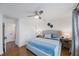 Bright main bedroom featuring hardwood floors and a ceiling fan at 2504 W Fletcher Ave, Tampa, FL 33618