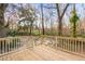 Wooden deck with steps leading down to a firepit area at 26451 Glenhaven Rd, Wesley Chapel, FL 33544