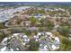 Aerial view of community with houses, pool, and tennis courts at 2650 Barksdale Ct, Clearwater, FL 33761