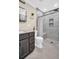 Modern bathroom with gray tile, walk-in shower, and built-in bench at 2650 Barksdale Ct, Clearwater, FL 33761