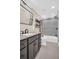 Bathroom with dark vanity, shower/tub combo, and gray tile floors at 2650 Barksdale Ct, Clearwater, FL 33761