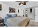 King-size bed in main bedroom with wood-look floors and barn-door style entry at 2650 Barksdale Ct, Clearwater, FL 33761