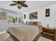 Main bedroom with king-size bed, wood accent wall, and large window at 2650 Barksdale Ct # 0, Clearwater, FL 33761