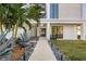 Landscaped walkway leading to the front entrance, featuring lush tropical plants at 2707 N Woodrow Ave # 3, Tampa, FL 33602