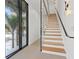 Modern glass and metal staircase with light wood steps and glass wall at 2707 N Woodrow Ave # 3, Tampa, FL 33602