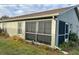 Side view of a single story house with screened enclosure at 276 Rochester St, Spring Hill, FL 34609