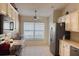 View of kitchen with white cabinets, stainless steel appliances and a window at 276 Rochester St, Spring Hill, FL 34609