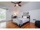 Spacious bedroom with hardwood floors, private balcony access and ceiling fan at 2812 W Neptune St, Tampa, FL 33629