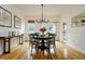 Elegant dining room with a round table, chandelier, and hardwood floors at 2812 W Neptune St, Tampa, FL 33629