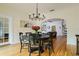 Bright dining room with chandelier and view into living room at 2812 W Neptune St, Tampa, FL 33629