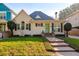 Cute yellow house with green door and well-kept lawn at 2812 W Neptune St, Tampa, FL 33629